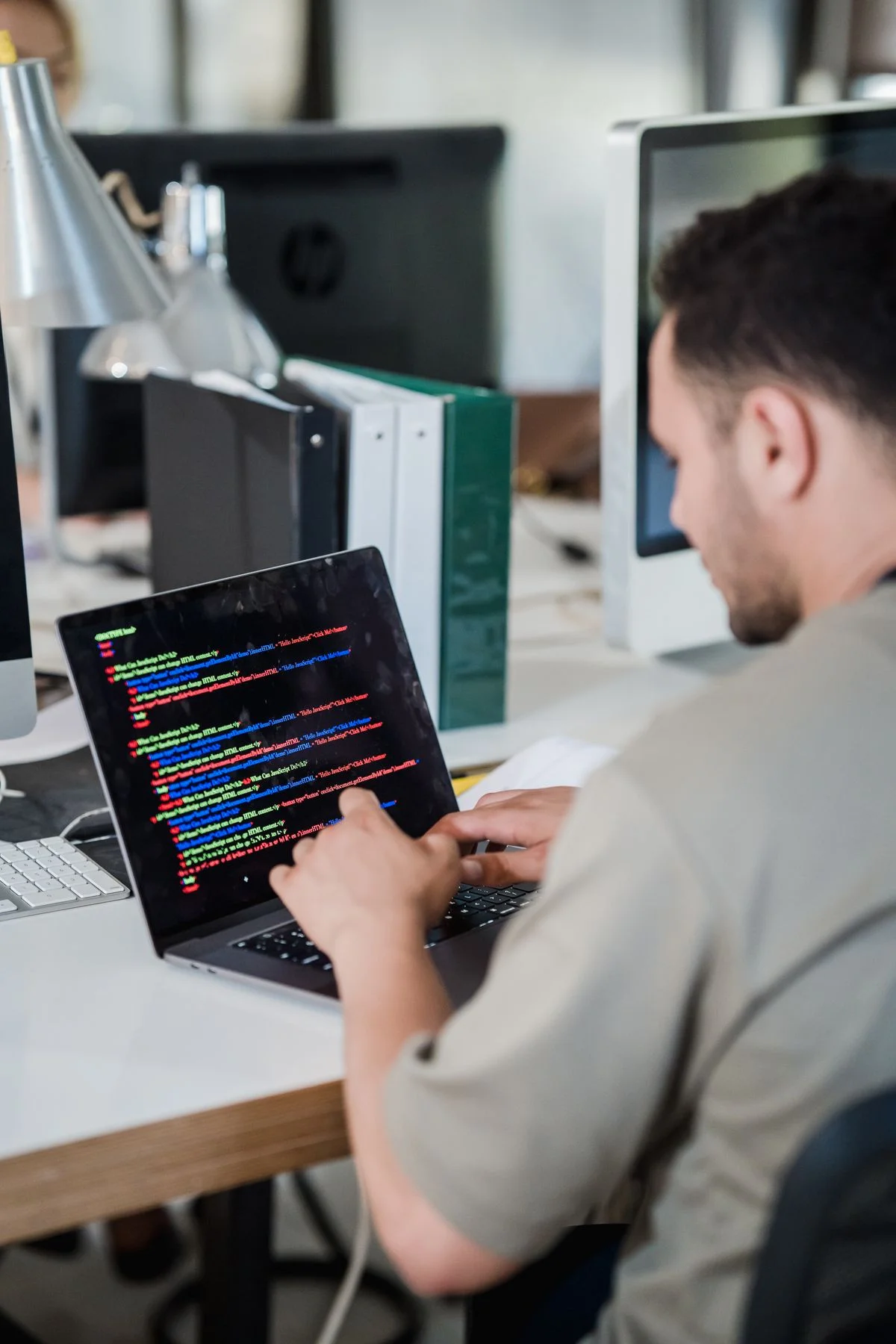 Software developer working on application code at a laptop